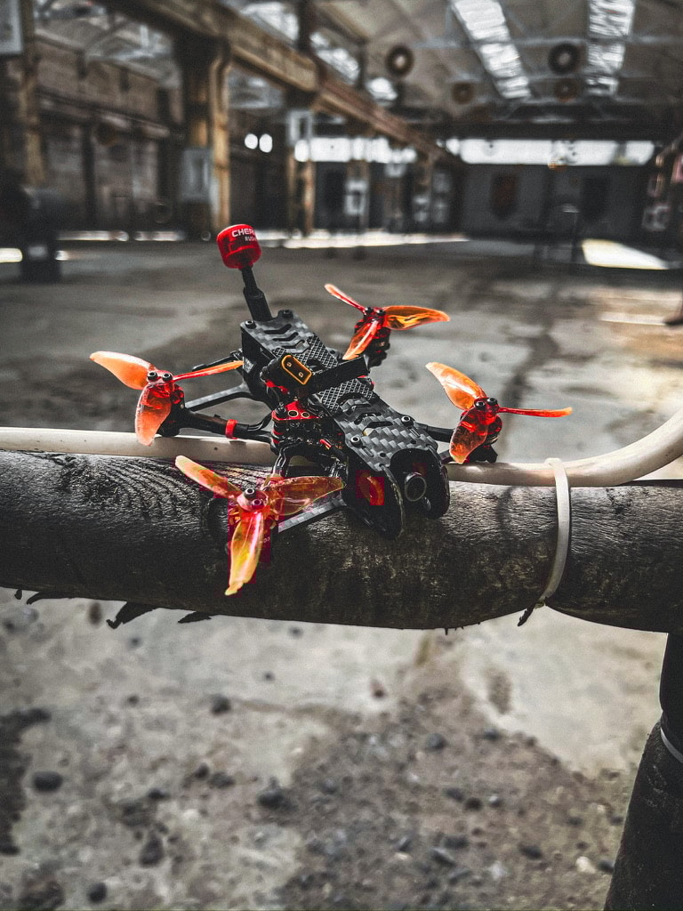 AlfaRC Fi-115 2.5-inch ultra-light micro FPV drone with yellow accents, compact AIO board, Caddx Baby Ratel 2 camera, and clean, crash-resistant 3D printed parts from Norial FPV.