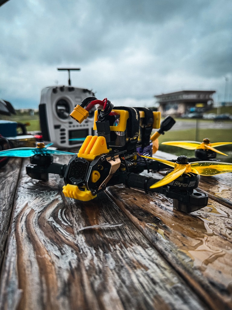 SpeedyBee Mario 5 DJI freestyle drone with yellow 3D printed parts, Gemfan blue and yellow propellers, from Norial FPV.